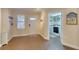 Hallway featuring wood floors, a front door, and an entrance to the laundry room at 3315 S Atlantic Ave # 705, Daytona Beach, FL 32118