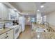 Well-lit kitchen with granite countertops, stainless steel sink, and a view into the hallway and laundry room at 3315 S Atlantic Ave # 705, Daytona Beach, FL 32118