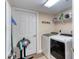 Laundry room with updated washer and dryer and wire shelving for storage at 3315 S Atlantic Ave # 705, Daytona Beach, FL 32118