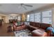 Spacious living room featuring a comfortable sectional sofa, ceiling fan, and windows overlooking a scenic view at 3315 S Atlantic Ave # 705, Daytona Beach, FL 32118