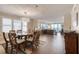 Open-concept living and dining area with a dining table, comfortable seating, hardwood floors, and ocean views at 3315 S Atlantic Ave # 705, Daytona Beach, FL 32118