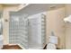 A tiled shower with glass block and shower head with bench in the bathing area at 3315 S Atlantic Ave # 705, Daytona Beach, FL 32118