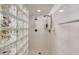 Modern shower with glass block and shower head with a convenient built in storage at 3315 S Atlantic Ave # 705, Daytona Beach, FL 32118