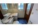 Bathroom featuring a double vanity, window, and dark blue tiled floor at 3550 Forest Branch Dr # A, Port Orange, FL 32129