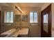 Bathroom featuring a double vanity, window, and mirror at 3550 Forest Branch Dr # A, Port Orange, FL 32129
