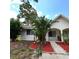 Charming single-story home with stucco exterior, mature landscaping, and a tiled roof under a bright blue sky at 3550 Forest Branch Dr # A, Port Orange, FL 32129