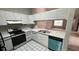 Bright kitchen with stainless steel appliances, white cabinets, and a contrasting black and white tile floor at 3550 Forest Branch Dr # A, Port Orange, FL 32129