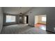Spacious carpeted living room with a vaulted ceiling and a ceiling fan with generous natural light from large windows at 3550 Forest Branch Dr # A, Port Orange, FL 32129