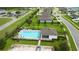 Aerial view of community pool area featuring a pool, clubhouse, and lounge chairs at 3565 Fernanda Dr, Deltona, FL 32738