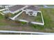 Aerial view of a backyard enclosed by a white fence with green grass at 3565 Fernanda Dr, Deltona, FL 32738