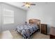 Cozy bedroom with warm-toned carpet, natural light and ceiling fan at 3565 Fernanda Dr, Deltona, FL 32738