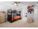 Cozy bedroom featuring a bunk bed with carpet flooring and natural light at 3565 Fernanda Dr, Deltona, FL 32738