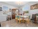 Bright dining room with tile floors, natural light and stylish wood china cabinet at 3565 Fernanda Dr, Deltona, FL 32738