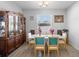 Bright dining room with tile floors, natural light and stylish wood china cabinet at 3565 Fernanda Dr, Deltona, FL 32738
