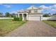 Charming two-story home with a brick driveway, manicured lawn, and attached two car garage at 3565 Fernanda Dr, Deltona, FL 32738