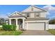 Charming two-story home featuring a well-maintained lawn, arched entry, and a spacious two-car garage at 3565 Fernanda Dr, Deltona, FL 32738
