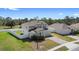 Charming two-story home with landscaped yard, brick driveway, and white picket fence at 3565 Fernanda Dr, Deltona, FL 32738