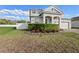 Two story home with a manicured lawn, garden and tree, and a paver driveway at 3565 Fernanda Dr, Deltona, FL 32738