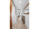 Inviting hallway with neutral paint, tile floors, and a decorative mirror leading to the living space at 3565 Fernanda Dr, Deltona, FL 32738