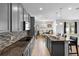 Modern kitchen featuring stainless steel appliances, granite countertops, and an adjacent dining area at 3565 Fernanda Dr, Deltona, FL 32738