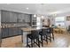 Modern kitchen with a large island, granite countertops, stainless steel appliances, and stylish bar stools at 3565 Fernanda Dr, Deltona, FL 32738