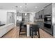 Modern kitchen featuring a spacious island, stainless steel appliances, and stylish bar stools at 3565 Fernanda Dr, Deltona, FL 32738