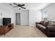 Open living room with ceiling fan, neutral carpet, and great lighting at 3565 Fernanda Dr, Deltona, FL 32738