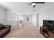 Spacious living room with plenty of natural light, ceiling fan, and neutral carpet at 3565 Fernanda Dr, Deltona, FL 32738