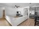 Open-concept living room features modern decor, tile floors, and seamlessly connects to the kitchen at 3565 Fernanda Dr, Deltona, FL 32738
