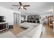 Open-concept living area connecting the kitchen and dining area, featuring tile floors and neutral walls at 3565 Fernanda Dr, Deltona, FL 32738