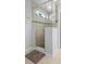 Glass enclosed shower with tiled walls, stone flooring, and overhead shower fixture at 3565 Fernanda Dr, Deltona, FL 32738