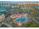 Beautiful aerial view of the pool and clubhouse, surrounded by palm trees and lush landscaping in a tropical community at 4626 Harbour Village Blvd # 3302, Ponce Inlet, FL 32127