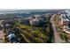 Stunning aerial view of community and golf course, surrounded by lush landscapes and city views at 4626 Harbour Village Blvd # 3302, Ponce Inlet, FL 32127