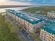 Stunning aerial view of waterfront condos with marina and lush surroundings at 4626 Harbour Village Blvd # 3302, Ponce Inlet, FL 32127