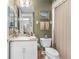 Bathroom with light green wallpaper featuring a single sink, toilet, and towel rack with decor at 4626 Harbour Village Blvd # 3302, Ponce Inlet, FL 32127