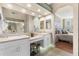 Bathroom showcasing double sinks, vanity area, and a mirrored closet, connecting to the main bedroom at 4626 Harbour Village Blvd # 3302, Ponce Inlet, FL 32127