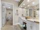 Elegant bathroom boasting dual sinks, a makeup vanity, and a private toilet room at 4626 Harbour Village Blvd # 3302, Ponce Inlet, FL 32127