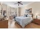 Relaxing bedroom features hardwood floors, a ceiling fan, and a bay window with a desk area at 4626 Harbour Village Blvd # 3302, Ponce Inlet, FL 32127