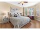 Inviting bedroom features hardwood floors, ceiling fan, and a bay window with natural light at 4626 Harbour Village Blvd # 3302, Ponce Inlet, FL 32127