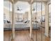 Bedroom with mirrored closet doors, ceiling fan, and bay window at 4626 Harbour Village Blvd # 3302, Ponce Inlet, FL 32127