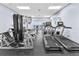Well-lit gym featuring treadmills and weight machines, and scenic ocean view out of the glass doors at 4626 Harbour Village Blvd # 3302, Ponce Inlet, FL 32127