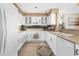Well-lit kitchen featuring white cabinetry, modern appliances, and stylish backsplash at 4626 Harbour Village Blvd # 3302, Ponce Inlet, FL 32127