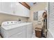Functional laundry room equipped with a washer, dryer, and plenty of cabinet space at 4626 Harbour Village Blvd # 3302, Ponce Inlet, FL 32127
