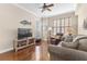 Inviting living room with hardwood floors, a television, and comfortable seating with natural light at 4626 Harbour Village Blvd # 3302, Ponce Inlet, FL 32127