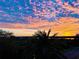 Beautiful sunset view over lush landscaping with palm trees and waterway at 4626 Harbour Village Blvd # 3302, Ponce Inlet, FL 32127