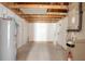 Unfinished basement space with exposed ceiling and a water heater at 4734 S Atlantic Ave, Ponce Inlet, FL 32127