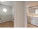 View into the bathroom featuring a walk-in closet, and white cabinets at 4734 S Atlantic Ave, Ponce Inlet, FL 32127