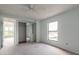 Bedroom with a ceiling fan, sliding closet doors and a serene atmosphere at 4734 S Atlantic Ave, Ponce Inlet, FL 32127