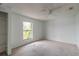 Light-filled bedroom with a ceiling fan and a window with tropical views at 4734 S Atlantic Ave, Ponce Inlet, FL 32127