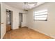 Bedroom features wood floors, ceiling fan, closet, and a bright window at 4734 S Atlantic Ave, Ponce Inlet, FL 32127